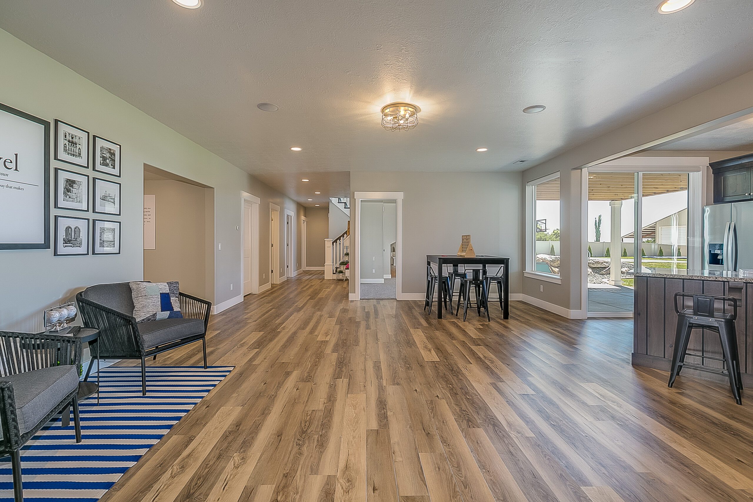 Open space in basement connected to kitchen, exercise room and theater room Open space in basement connected to kitchen, exercise room and theatre room
